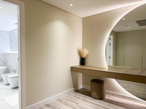 a bathroom with a sink and a mirror at Fabulous 2BR Apartment at 5 Star Resort in Dubai