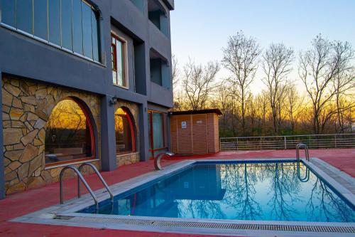 a swimming pool in front of a building at Kaltur Boutique Hotel in Yalova