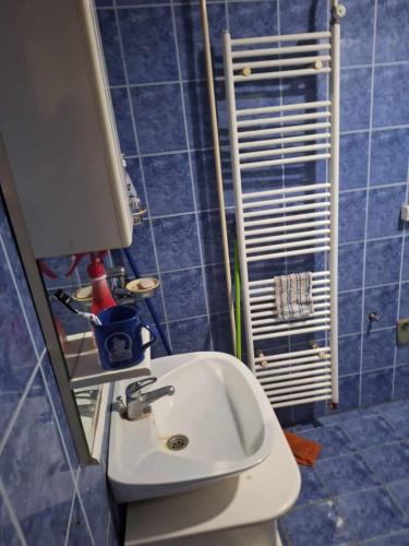 a blue bathroom with a sink and a mirror at Komforna kuca Pale in Pale