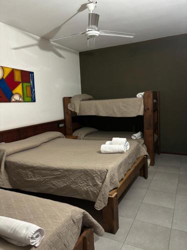 a room with two beds and a ceiling at Claro De Luna Hotel centro in Río Tercero
