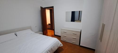 a bedroom with a bed and a dresser and a mirror at APPARTAMENTO SERENA in Bagnolo Mella