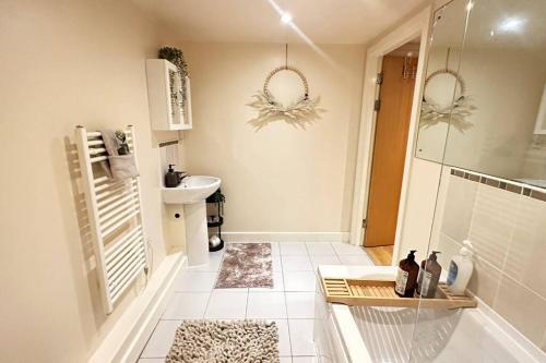 a bathroom with a sink and a toilet at Urban Chic: 2 Bedroom Apartment in City Centre + FREE Parking in Birmingham
