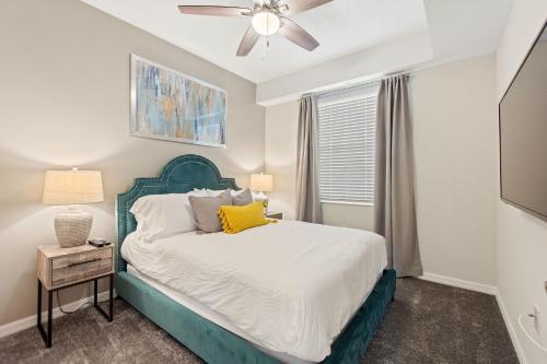 a bedroom with a bed and a ceiling fan at Serenity Haven - Storey Lake #701 by Shine Villas in Kissimmee