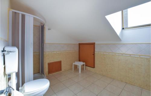 a bathroom with a toilet and a sink at 3 Bedroom Amazing Apartment In Castel Di Tusa in Castel di Tusa