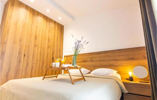 - une chambre avec un lit et une tête de lit en bois dans l'établissement Nice Home In Stankovci With Kitchen, à Stankovci