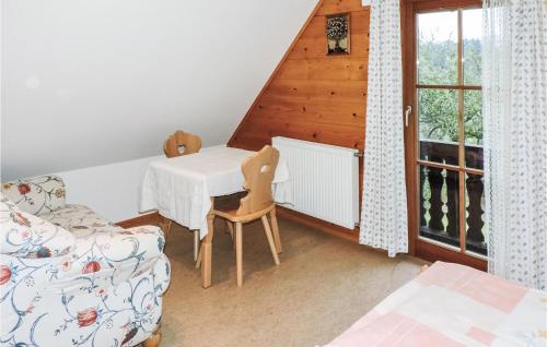 a room with a table and a couch and a window at Amazing Home In Fischbach With 2 Bedrooms And Wifi in Fischbach