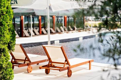 due sedie con ombrellone accanto alla piscina di Heaven a Sunny Beach
