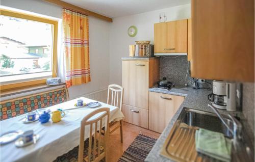 a small kitchen with a table and a window at Stunning Apartment In Mhlbach With Kitchen in Hollersbach im Pinzgau