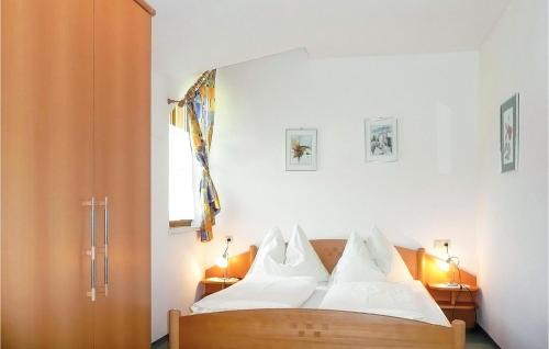a bedroom with a bed with white sheets and a window at Lovely Apartment In Radstadt With Wifi in Radstadt