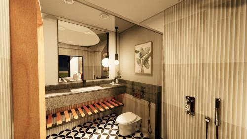 ein Badezimmer mit einem Waschbecken, einem WC und einem Spiegel in der Unterkunft Vintclub Resort in Lucknow