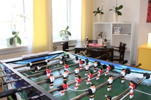a large pool table with people on it in a living room at Vienna House Easy by Wyndham Rostock in Rostock