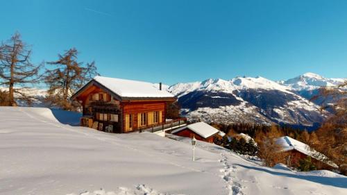 a log cabin in the snow on a mountain at Narnia SKI IN & SKI OUT chalet 14 pers in Les Collons