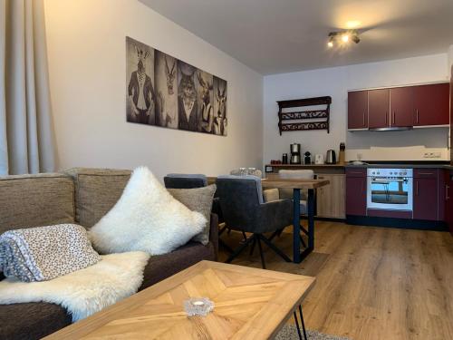 a living room with a couch and a table at Almlodge Flachau in Flachau