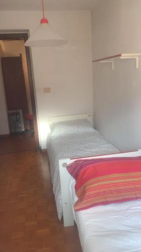 a room with two beds in a room at La Casa dei Nonni in Arta Terme