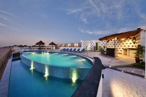 a swimming pool on top of a hotel at The Fern Leo Beach Resort , Madhavpur in Porbandar