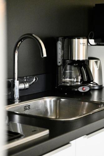 a coffee maker sitting on top of a kitchen sink at De Viool Appartementen in Buren