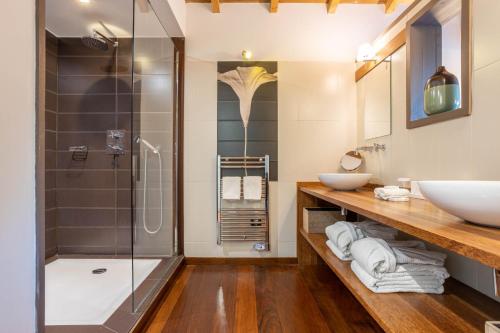 a bathroom with two sinks and a shower at Hôtel Côté Sable in Cap-Ferret