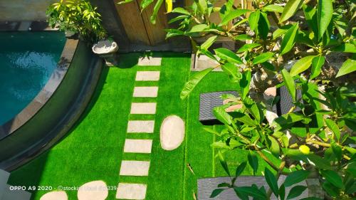 an overhead view of a backyard with a pool and green grass at DANU HOUSE UBUD in Ubud