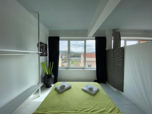 a bedroom with a yellow bed and a window at COMBO Acropolis view 6 bedrooms 4 bathrooms in Athens