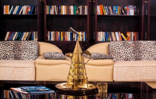 a living room with a couch and a gold tea kettle on a table at Kilulu Luxury Island, Watamu in Watamu