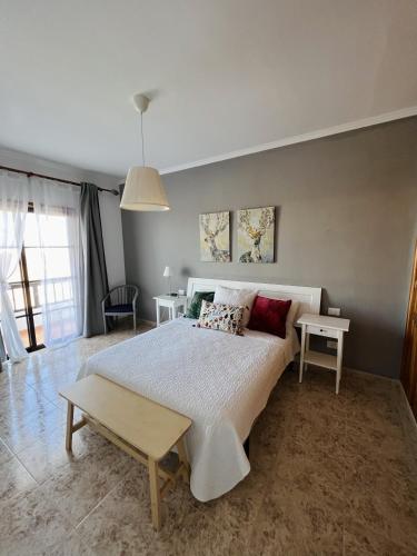 a bedroom with a large bed and two tables at Casa Cielo in Arrecife