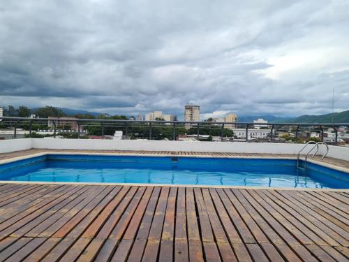 a swimming pool on the roof of a building at Paseo Balcarce Suite in Salta