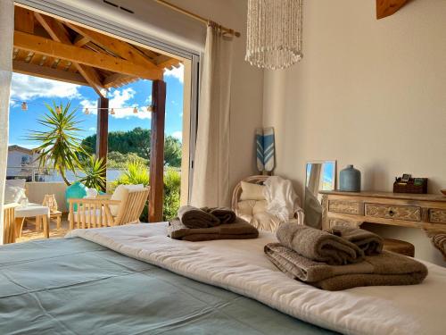 a bedroom with a large bed with towels on it at Au Bonheur Dezange in Pézenas
