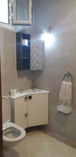 a small bathroom with a toilet and a sink at Beach Houses in Sfax