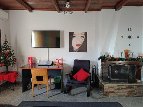 a living room with a desk and a christmas tree at Domi's Rooftop Apartment in Thessaloniki