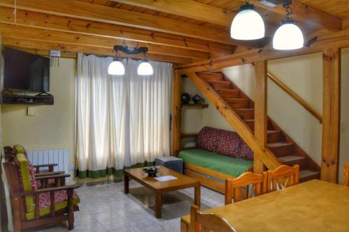 sala de estar con sofá y mesa en Complejo Moquehue en Villa Pehuenia