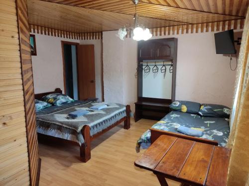 a living room with two beds and a table at V Ulyanu in Yaremche