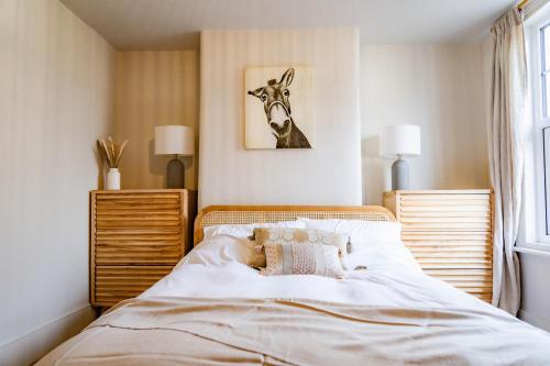 a bedroom with a bed with a deer picture on the wall at Benyon Street Townhouse in Shrewsbury