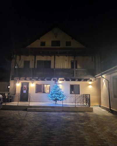 a christmas tree in front of a building at night at Adac Boutique Hotel in Bucharest