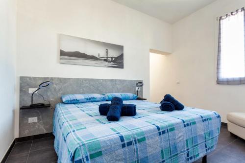 a bedroom with a bed with blue pillows on it at [5 min Aeroporto-Stazione] Parma in Parma