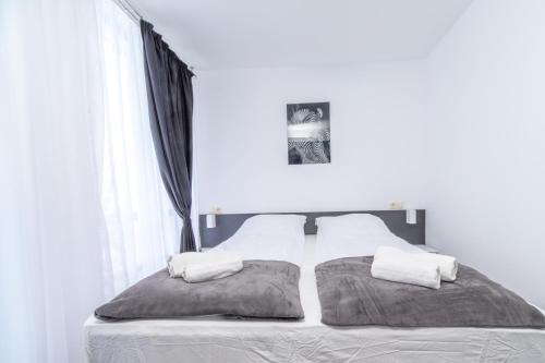 a bedroom with a bed with two pillows on it at PARADISE RELAX APARTMENT in Bansko