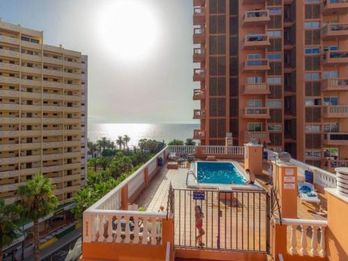 a balcony with a swimming pool and some buildings at Live Puerto Valle Luz in Puerto de la Cruz