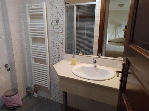 a bathroom with a sink and a mirror at BLUE ΡΙΚΕΑ in Arachova