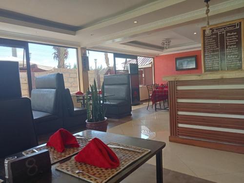 restauracja ze stołem i krzesłami w pokoju w obiekcie Kirubis Safari Lounge w mieście Narok