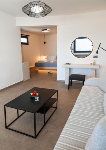 a living room with a couch and a table at North Wind Luxury Suites in Oia