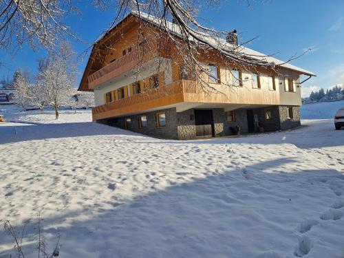 a house in the snow with a lot of snow at Turistična kmetija Ramšak in Zreče