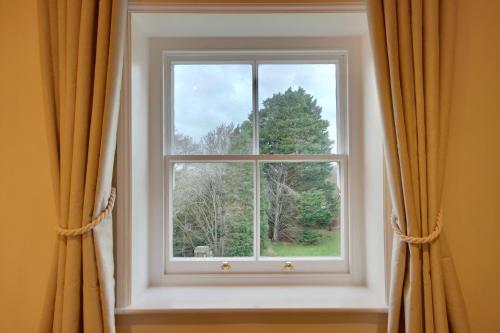 a window with orange curtains in a room at Orange Grove Hotel & Gardens in Southampton