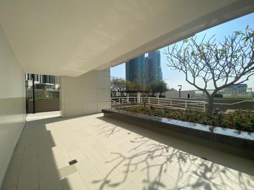 a building with a view of a tree and buildings at Sea View - 2BHK - Al Reem Island 6ppl Free Transportation from AD Airport in Abu Dhabi