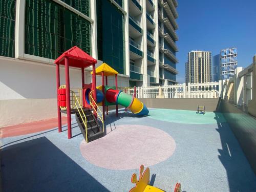 a playground with a slide in a building at Sea View - 2BHK - Al Reem Island 6ppl Free Transportation from AD Airport in Abu Dhabi