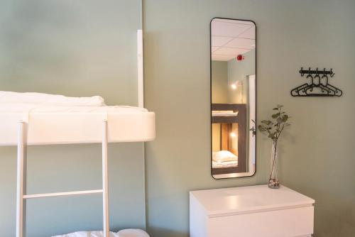 a bedroom with a bunk bed and a mirror at Göteborg Hostel in Gothenburg
