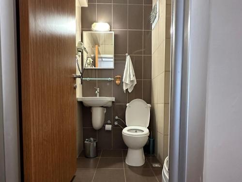 a small bathroom with a toilet and a sink at Topkapı Otel Özyavuz in Istanbul