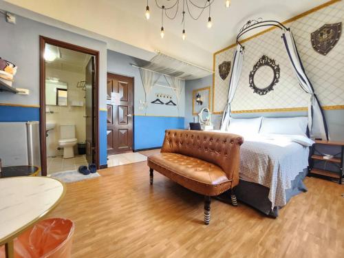 a bedroom with a bed and a leather chair at 一中喵喵 有統編收據 禁菸 非自助 in Taichung
