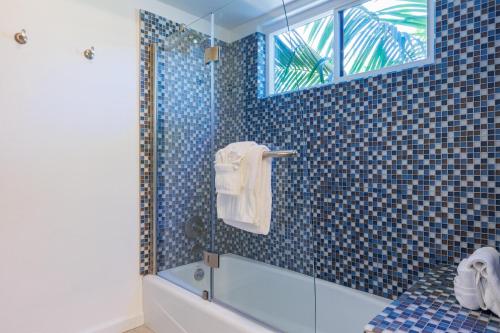 a blue tiled bathroom with a shower and a tub at ENC-1408 - Enchanting Encinitas Retreat in Encinitas