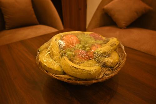 a bowl of fruit on a wooden table at Swet Palash Resort in Purulia