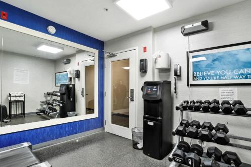 a room with a gym with dumbbells on the wall at Staybridge Suites Columbia - Baltimore by IHG in Columbia