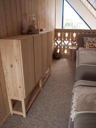 a bedroom with two beds and a wooden cabinet at Owczarnia Tatry in Bukowina Tatrzańska